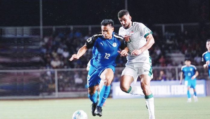 Philippine Azkals’ Armani Aguinaldo kicks the ball away from an Iraqi defender. PNMFT PHOTO