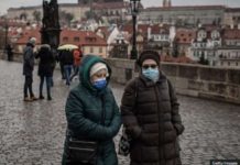 Czech Republic struggles to contain surge of whooping cough Two women walk side by side in Prague wearing face masks. GETTY IMAGES