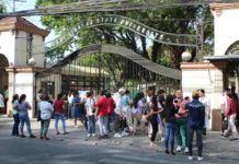 With slots limited, race begins for Iloilo college scholarship Eager parents of hopeful senior high school students who will be taking the college admission examination patiently wait outside the West Visayas State University-Main Campus in La Paz, Iloilo City on Sunday, March 10. AJ PALCULLO/PN