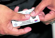 A Land Transportation Office (LTO) staff member shows a brand new student driver’s license at the LTO Quezon City District Office in Centris Station. The LTO had been facing a supply shortage of plastic cards for driver’s licenses. INQUIRER PHOTO/LYN RILLON