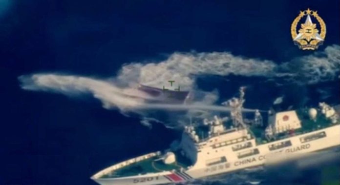 PCG_resized This frame grab from aerial video footage taken and released on March 23, 2024, by the Armed Forces of the Philippines, shows a vessel described by the Philippine armed forces as a China Coast Guard ship (bottom R) deploying water cannon against the Philippine military-chartered civilian boat Unaizah May 4 during its supply mission near the Second Thomas Shoal in disputed waters of the South China Sea. AFP FILE PHOTO