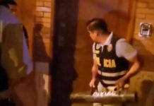 Peru President’s home raided for Rolex watches A police officer is pictured trying to break open a door during the raid at President Dina Boluarte’s home in Lima, Peru. REUTERS