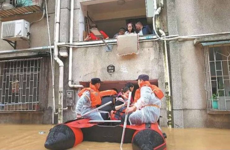Rescuers evacuate stranded residents on Saturday in the flood-hit city of Shaoguan, Guangdong province of China. Xinhua