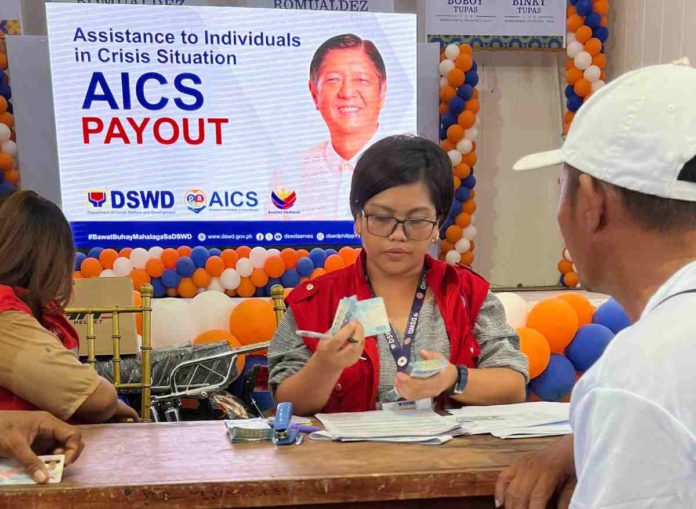 A financial assistance of P5,000 is released by the Department of Social Welfare and Development to each of nearly 1,500 beneficiaries in the towns of Sara and Carles in Iloilo Province on Saturday, April 27, 2024. PHOTO OF FROM DSWD-6