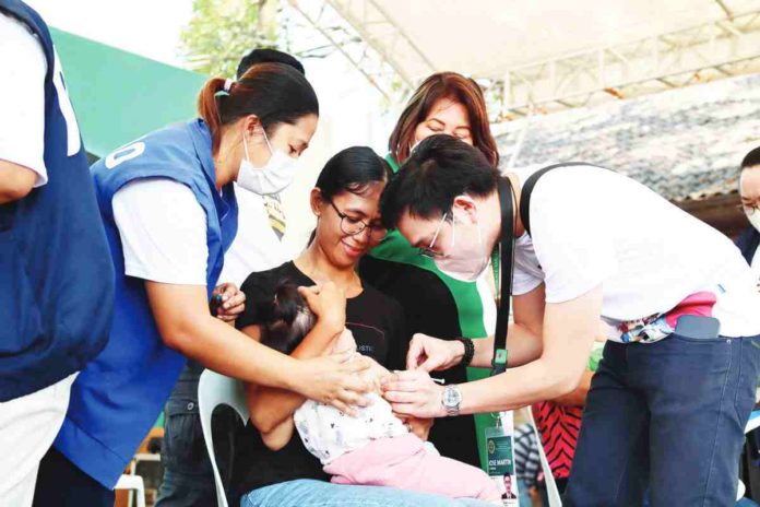ime_herd_immunity_resized Dr. Jose Martin Atienza, regional coordinator for the National Immunization Program at the Department of Health – Region 6 administers a measles-rubella vaccine on a child as part of the 1st Regional World Immunization Week Celebration and MR-bOPV Supplemental Immunization Activity Kick-Off held in Kabankalan City, Negros Occidental last year. DOH WV CHD via Philippine Information Agency – Western Visayas