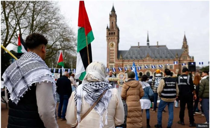 Demonstrators with Palestinian and Nicaraguan flags gather outside the International Court of Justice in The Hague on April 8. Reuters