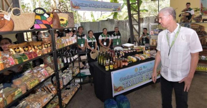 panaad_fest_sales_resized Gov. Eugenio Jose Lacson checks out the display at the trade fair of the Food Security Fair and Exhibit at Panaad Park and Stadium in Bacolod City on Monday, April 15. The event is part of the 28th Panaad Sa Negros Festival. PIO NEGROS OCCIDENTAL PHOTO