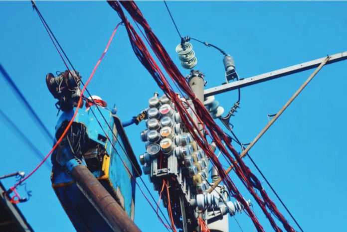 power supply Workers inspect an electric meter installed above ground in Manila on January 11, 2024. MARK DEMAYO/ABS-CBN NEWS PHOTO
