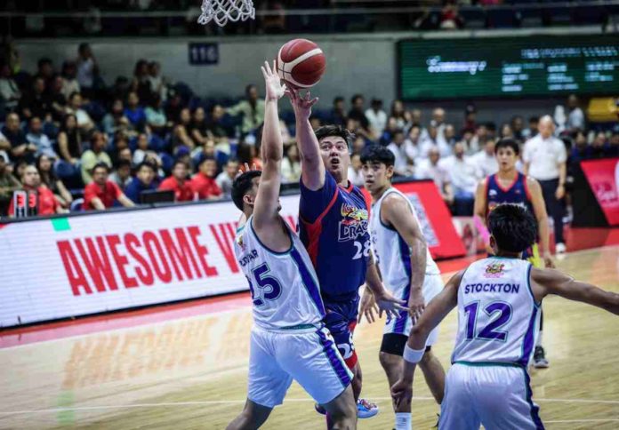 sports beau Rain or Shine Elasto Painters’ Beau Belga goes for a reverse shot against the defense of Aklanon Keith Zaldivar of Converge FiberXers. PBA PHOTO