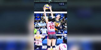 University of Santo Tomas Golden Tigresses’ Angeline Poyos smashes the ball towards the University of the East Lady Warriors defense. UAAP PHOTO