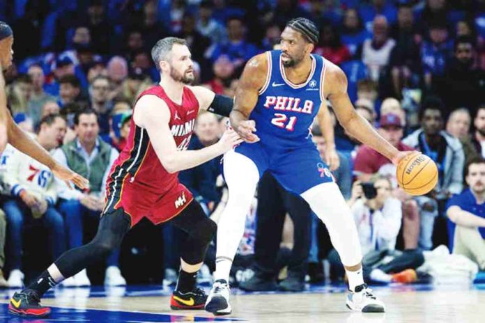 sports_76ers_resized Philadelphia 76ers’ Joel Embiid (21) controls the ball against Miami Heat’s Kevin Love (42). Photo courtesy of Bill Streicher/USA TODAY Sports