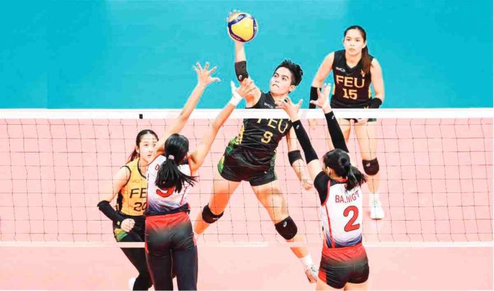 sports_FEU_resized Far Eastern University Lady Tamaraws’ Chenie Tagaod drops the ball to the defense of University of the East Lady Warriors. UAAP PHOTO