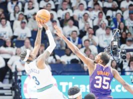 Minnesota Timberwolves’ Jaden McDaniels (3) shoots against Phoenix Suns’ Kevin Durant (35). BRAD REMPEL-USA TODAY SPORTS