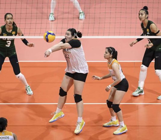 University of Santo Tomas Golden Tigresses’ Bianca Plaza saves the ball from an attack by De La Salle University Lady Spikers. UAAP PHOTO