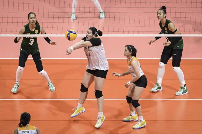 University of Santo Tomas Golden Tigresses’ Bianca Plaza saves the ball from an attack by De La Salle University Lady Spikers. UAAP PHOTO