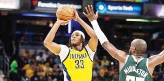 Indiana Pacers’ Myles Turner (33) shoots the ball while Milwaukee Bucks’ Khris Middleton (22) defends. TREVOR RUSZKOWSKI/USA TODAY SPORTS