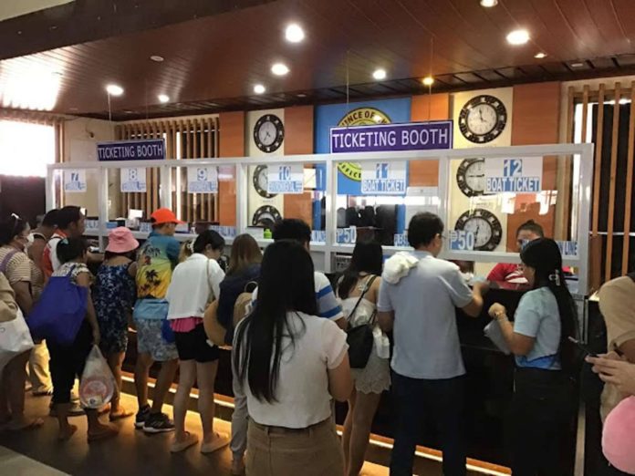A proposed ticketing solution, which will unify payments for environmental, boat, and terminal fees, is seen to address the anticipated queues of tourists on Boracay Island during peak seasons. BOY RYAN ZABAL/AKEAN FORUM