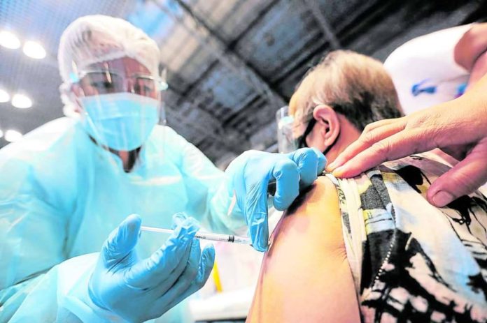 vax_copy_resized A nurse vaccinates a senior citizen who ignored claims against COVID-19 vaccines. INQUIRER FILE PHOTO