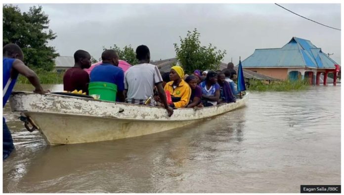 People are being rescued in a canoe in Rufiji district in a coastal region of Tanzania. EAGAN SALLA /BBC