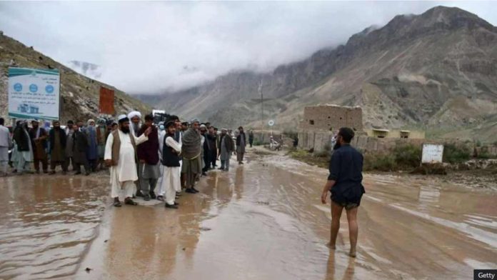 Afghanistan_resized Afghans gather along a road between Samangan and Mazar-i-Sharif covered in mud following a flash flood after a heavy rainfall. GETTY IMAGES
