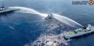 This frame grab from handout video footage taken and released on April 30, 2024 by the Philippine Coast Guard (PCG) shows the Philippine Coast Guard ship BRP Bagacay (C) being hit by water cannon from Chinese coast guard vessels near the Chinese-controlled Scarborough shoal in disputed waters of the South China Sea. The Philippines said the China Coast Guard fired water cannon on April 30 at two of its vessels, causing damage to one of them, during a patrol near a reef off the Southeast Asian country. AGENCE FRANCE-PRESSE