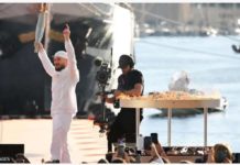 Olympic flame arrives in France French rapper Julien Mari aka Jul holds the Olympic Torch after lighting the Olympic and Paralympic torch relays cauldron in Marseille. GETTY IMAGES