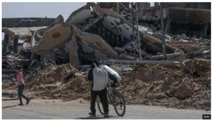 Gaza_resized A displaced Palestinian man pushes a bike along Salah al-Din road in southern Gaza after fleeing Rafah. The Israeli military ordered an estimated 100,000 residents of eastern Rafah to evacuate. EPA