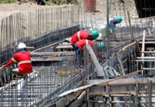 Construction workers perform their tasks for a road project in Imus, Cavite. They are protected by hard hats and long-sleeved garments but must limit sun exposure between 10 a.m. and 4 p.m. when ultraviolet rays are strongest. President Ferdinand Marcos Jr. has ordered the Regional Tripartite Wages and Productivity Boards to initiate a timely review of the minimum wage rates. PNA
