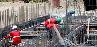 Construction workers perform their tasks for a road project in Imus, Cavite. They are protected by hard hats and long-sleeved garments but must limit sun exposure between 10 a.m. and 4 p.m. when ultraviolet rays are strongest. President Ferdinand Marcos Jr. has ordered the Regional Tripartite Wages and Productivity Boards to initiate a timely review of the minimum wage rates. PNA
