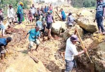 Villagers in Yambali, Papua New Guinea dig rubbles and mud hoping to find survivors following a landslide. AP