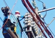 A worker inspects an electric meter installed above ground in Manila. MARK DEMAYO/ABS-CBN NEWS PHOTO