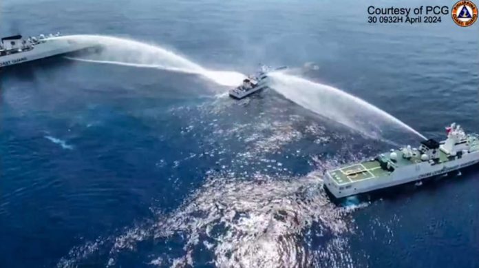 china_resized This frame grab from handout video footage taken and released on April 30, 2024, by the Philippine Coast Guard (PCG) shows the Philippine Coast Guard ship BRP Bagacay (C) being hit by a water cannon from Chinese Coast Guard vessels near the Chinese-controlled Scarborough shoal in disputed waters of the South China Sea. The Philippines said the China Coast Guard fired a water cannon on April 30 at two of its vessels, causing damage to one of them, during a patrol near a reef off the Southeast Asian country. PHOTO BY HANDOUT / PHILIPPINE COAST GUARD / AFP