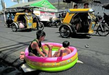 Children make do with an inflatable pool with just enough water to keep themselves cool in this street scene at Baseco compound in Tondo, Manila. RICHARD A. REYES, PHILIPPINE DAILY INQUIRER