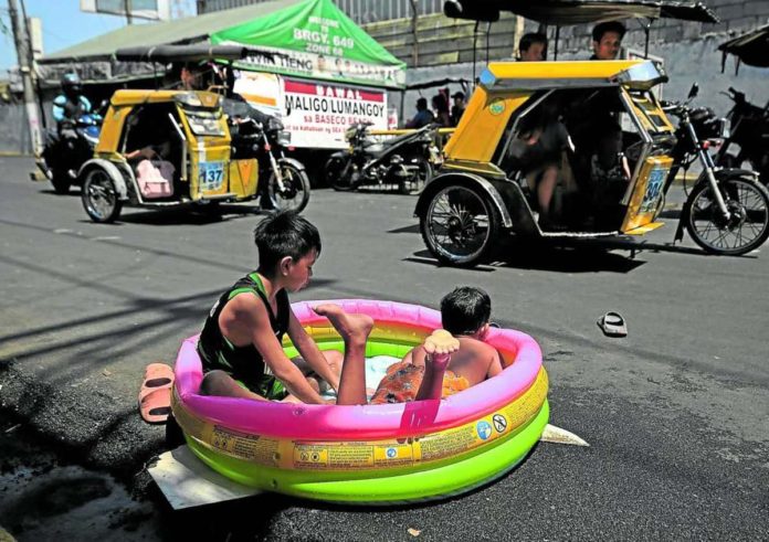 oratio_resized Children make do with an inflatable pool with just enough water to keep themselves cool in this street scene at Baseco compound in Tondo, Manila. RICHARD A. REYES, PHILIPPINE DAILY INQUIRER