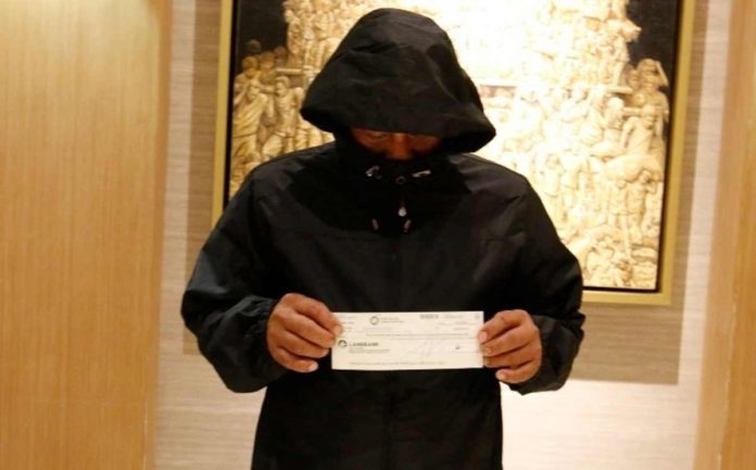Photo shows the real winner holding the cheque for the Jackpot prize for the Megalotto 6/45 drawn last April 22, 2024.