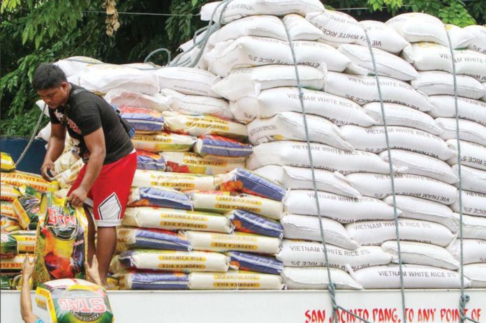 The Philippines’ 2025 rice imports were projected to climb even higher than the expected 4.1 million metric tons, according to the United States Department of Agriculture monthly global grains report for May. Photo shows porters loading sacks of rice to be placed in a warehouse in Dagupan Street in Tondo, Manila. RAPPLER PHOTO