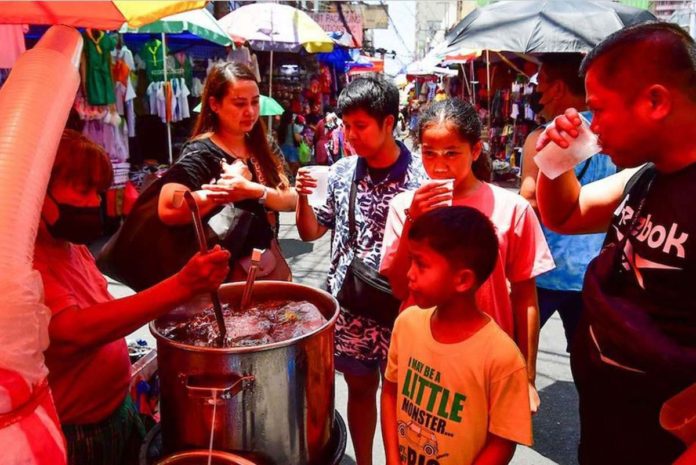 small_businesses People carry a beverage while traversing the streets in Manila on April 3, 2024. Health experts advise the public to take precautions and stay hydrated as the country experiences high heat levels amid the dry season recently announced by Philippine Atmospheric, Geophysical and Astronomical Services Administration. MARK DEMAYO/ABS-CBN NEWS PHOTO