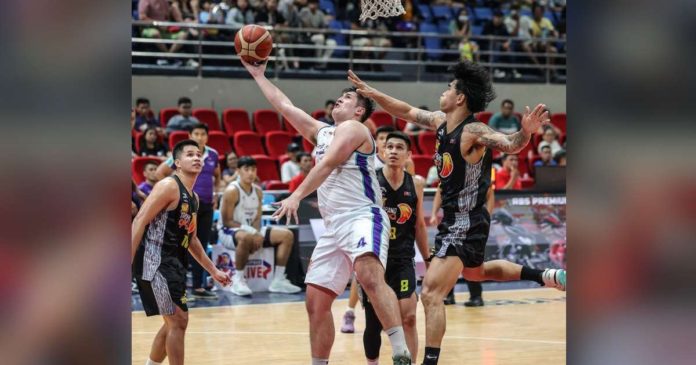 sports Converge_superimposed Converge FiberXers’ Patrick Maagdenberg evades the defense of TNT Tropang Giga’s Glenn Khobuntin for a reverse basket. PBA PHOTO