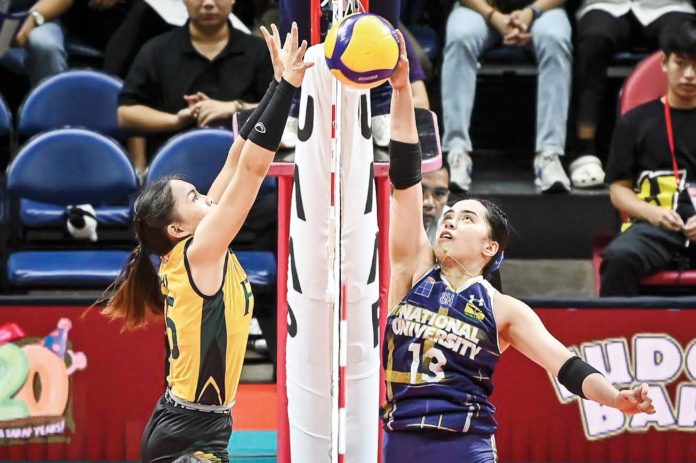 sports-NU Guimarasnon Camille Lamina of the National University Lady Bulldogs attempts to drop the ball against Far Eastern University Lady Tamaraws’ Gerzel Petallo. UAAP PHOTO
