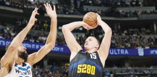 Denver Nuggets’ Nikola Jokić shoots over the defense of Minnesota Timberwolves' Rudy Gobert. PHOTO BY DAVID ZALUBOWSKI/ASSOCIATED PRESS