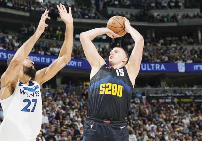 sports-denver Denver Nuggets’ Nikola Jokić shoots over the defense of Minnesota Timberwolves' Rudy Gobert. PHOTO BY DAVID ZALUBOWSKI/ASSOCIATED PRESS