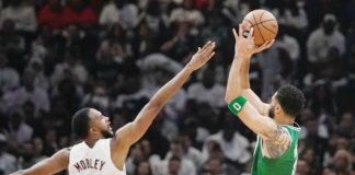 Boston Celtics’ Jayson Tatum (0) shoots over Cleveland Cavaliers' Evan Mobley (4). PHOTO COURTESY OF SUE OGROCKI/AP