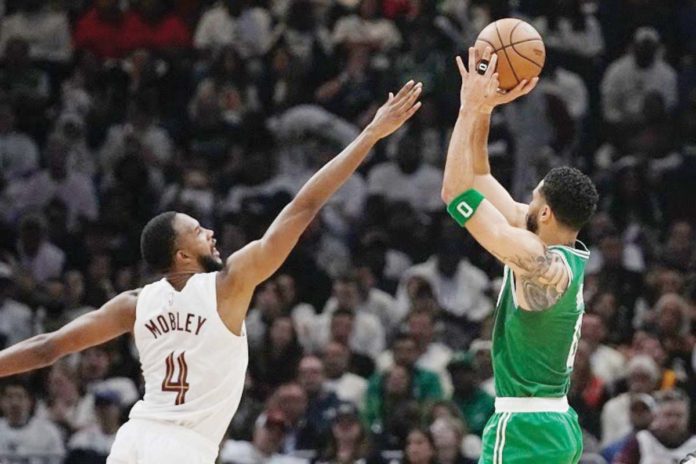 sports_Boston_resized Boston Celtics’ Jayson Tatum (0) shoots over Cleveland Cavaliers' Evan Mobley (4). PHOTO COURTESY OF SUE OGROCKI/AP