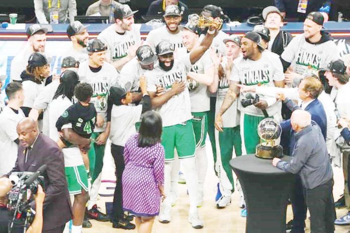 sports_Boston_resized_resized Boston Celtics’ Jaylen Brown raises his NBA Eastern Conference Finals MVP trophy. PHOTO COURTESY OF BOSTON CELTICS