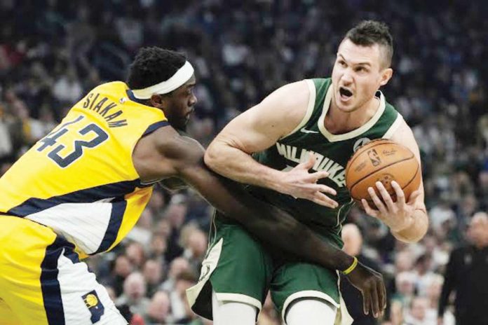 Milwaukee Bucks forward Danilo Gallinari protects the ball from the defense of Indiana Pacers’ Paskal Siakam. PHOTO courtesy of Morry Gash/AP