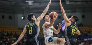 Rain or Shine Elasto Painters’ Adrian Nocum splits the defense of TNT Tropang Giga’s Calvin Oftana and Kib Montalbo for an inside hit. PBA PHOTO