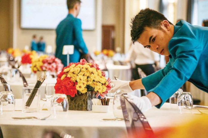 A waiter uses white gloves to keep from staining clean glasses at a hotel facility in Makati City, the country's major business district. JONATHAN CELLONA/ABS-CBN NEWS FILE PHOTO