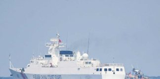 A China Coast Guard ship maneuvers past a Philippine fishing boat during the distribution of fuel and food to fishers by the civilian-led mission Atin Ito (This Is Ours) Coalition, in the disputed South China Sea on May 16, 2024. AFP