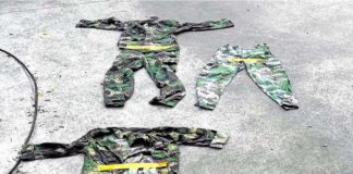 FAKE OR NOT, STILL ALARMING. Authorities show some of the military uniforms and pins found in a POGO complex in Porac, Pampanga, raided by a team led by the Presidential Anti-Organized Crime Commission on complaints of human trafficking. PAOCC PHOTO