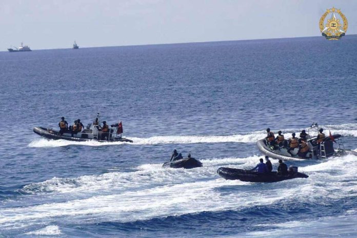 This handout photo taken on May 19, 2024 and received on June 4, 2024 from the Armed Forces of the Philippines shows two Chinese rigid-hulled inflatable boats (left and right) maneuvering close to Philippine personnel on board their boats (second from left and 2nd fron right) near the Philippine outpost at Second Second Thomas Shoal in disputed waters of the South China Sea. PHOTO BY HANDOUT / ARMED FORCES OF THE PHILIPPINES / AFP